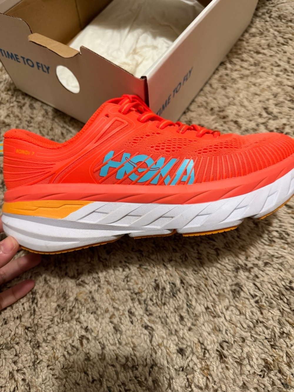 Hoka Coral-Orange Running Shoe with Blue Logo